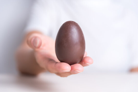 close up of hands holding an easter egg, holy week, religious celebration