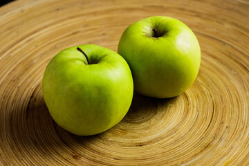 Apple on beatiful wooden tray laying side by side 