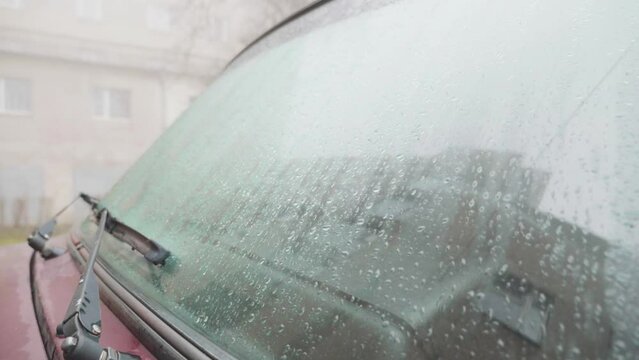 the windshield of the car is wet from dew