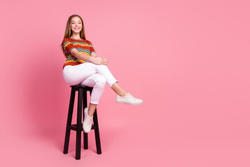 Full body portrait of satisfied glad cute person sit chair empty space ad isolated on pink color...