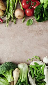 Vegetables frame background with copy space for a text. Healthy food, fresh vegetables set on a kitchen stone desk. Stock footage vertical video 4k
