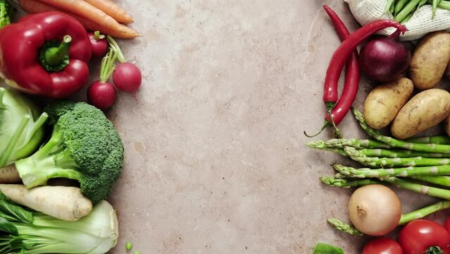 Vegetables frame background with copy space for a text. Healthy food, fresh vegetables set on a kitchen stone desk. Stock footage video 4k