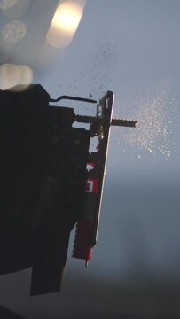 Experience the dynamic energy of woodworking in action with our captivating 4K vertical slow motion footage. Watch as an electric jigsaw gracefully powers up in mesmerizing slow motion, sending wood c