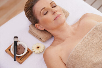 Woman, face and top view for facial at spa, massage and wellness with calm for zen and self care....
