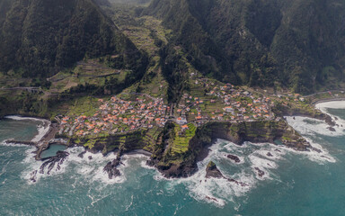 Aerial view of Seixal, a little village by the ocean with waves and surrounded with incredible...