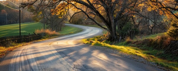 Curved country road in autumn at sunset