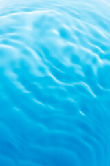 Blue water surface,Transparent blue clear water surface texture with ripples, splashes and bubbles. Abstract nature background Water waves in sunlight. Cosmetic moisturizer micellar toner emulsion. 