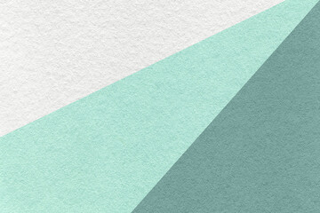 Texture of old craft white, cyan and teal color paper background, macro. Vintage abstract mint cardboard