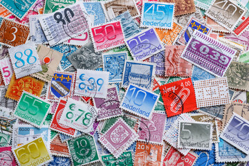 Ukraine, Kiyiv - January 12, 2023 Netherlands Postage stamps..Postage stamps.A collection of world stamps in a pile.Postage stamps from different countries and times - obrazy, fototapety, plakaty