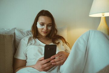 Woman using smartphone before going to sleep