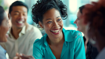 Obraz premium A woman is laughing joyfully during a meeting with colleagues.