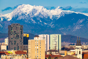 Ljubljana, Slovenia: High-rise modern residential buildings and the snowy Alps 