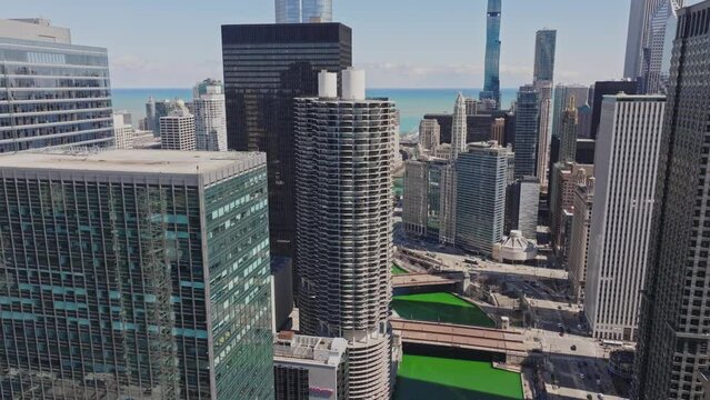 Cinematic Drone Beautiful sunny day Chicago Green River on St Patrick Day 2024 Aerial 4k blue water lake Michigan downtown Marina City USA