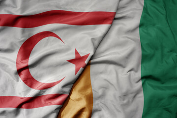 Obraz premium big waving national colorful flag of cote divoire and national flag of northern cyprus.