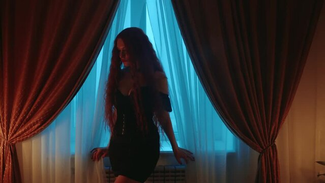 shadow silhouette beauty gothic woman vampire walking in dark night dusk classic room window. Fantasy lady vamp girl evil goth sexy evening makeup red lips long hair, short black dress art portrait 4k