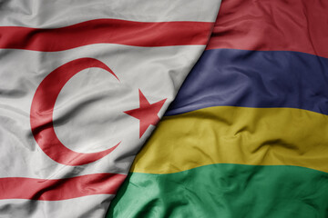 big waving national colorful flag of mauritius and national flag of northern cyprus.