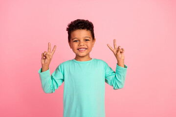 Photo portrait of adorable little boy show double v-sign wear trendy aquamarine garment isolated on...