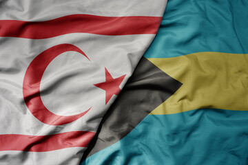 big waving national colorful flag of bahamas and national flag of northern cyprus.
