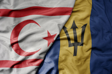 big waving national colorful flag of barbados and national flag of northern cyprus.