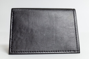 Closeups of black leather wallet on white background.