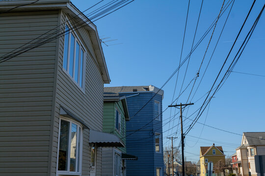 Old residential houses in a row in Wallington New Jersey, wires hanging from poles. High-quality photo