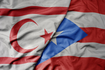 big waving national colorful flag of puerto rico and national flag of northern cyprus.