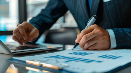 Detail shot of a business professional using a tablet to review digital charts and data