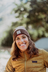 Smiling woman in winter hat and jacket outdoors