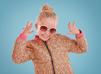 Little girl, portrait and fashion with sunglasses in studio for trendy, cool and funky style with...