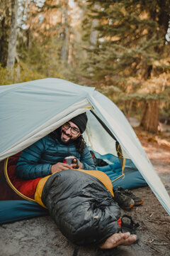 Camper smiling in a tent