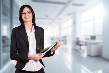 Portrait of a professional business woman standing in office.