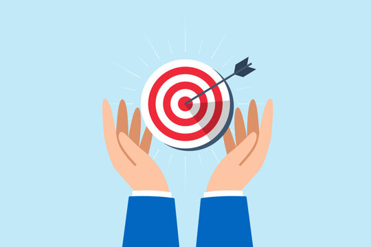 Businessman hand holds bullseye with arrow, illustrating aiming business target accurately. Concept of setting goals, focus and concentration to achieve success, pursuing objectives with purpose