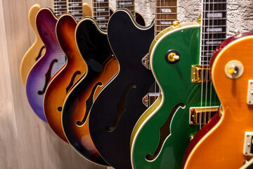 Group of electric guitars hanging on the wall in a music shop
