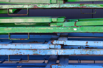 Alte blaue und grüne Eisenstangen auf einem Stapel