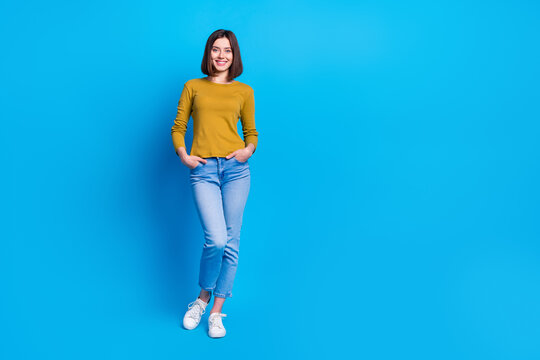 Full length photo of cheerful adorable lady dressed shirt walking empty space isolated blue color background