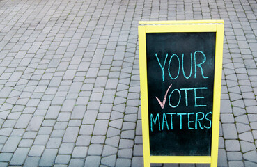 Message "your voice matters"is written in chalk on old wooden rustic board.Legal and democratic rights of the people, every vote counts. The concept of the election campaign and electoral agitation.