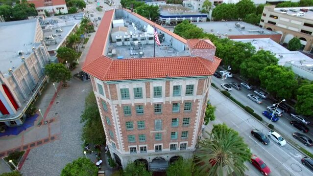 Aerial Tilt Up Shot Of The Culver Hotel On Residential Landscape During Scenic Sunset - Culver City, California