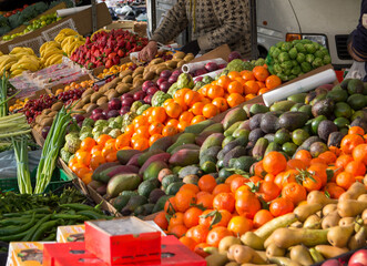 a display of vegetables including cucumbers cucumbers and tomatoes