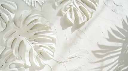Abstract white plaster relief with tropical monstera leaf patterns casting soft shadows