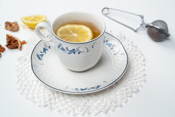 Still life with fine porcelain tea cups and accessories on a textured white background - 764139330