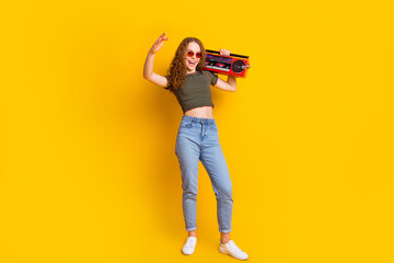Photo of cheerful lovely girl wea stylish clothes dance have fun listen music summer vacation isolated on vivid yellow color background