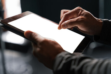 Person using tablet with white screen and hand gestures - obrazy, fototapety, plakaty