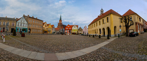 Panoramic view of old market square with town hall and gothic church of St. Mary in Trzebiatow,...