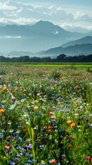 Fototapeta premium A field of colorful wildflowers stretching into the distance, set against a backdrop of majestic mountains under a clear blue sky.