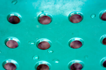 Abstract close-up view of green plastic chair outdoors of public park at Swiss City of Zürich on a blue cloudy spring day. Photo taken March 21st, 2024, Zurich, Switzerland.
