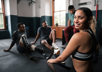 Fototapeta premium Group with prosthetic legs relaxing on gym floor during leisure event