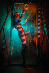 Futuristic sci fi girl posing at the old factory. Cyberpunk woman concept.