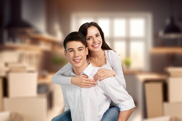 Portrait Of Smiling Young Couple Among Boxes in New Home