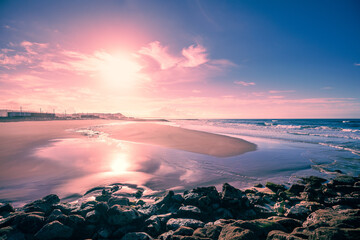 Seascape in the evening at low tide. Seacoast of Costa da Caparica city at sunset. Portugal - 764167564