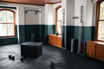 Empty gym with black hardwood flooring and ottoman